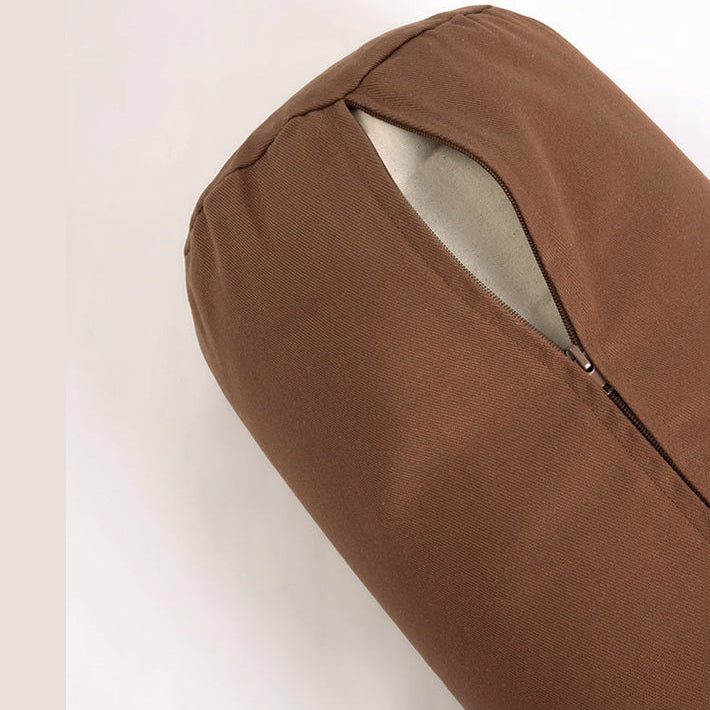 Brown fabric yoga bolster with a zipper on a white background