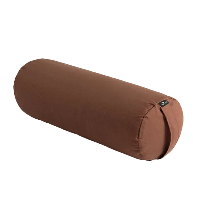 Brown cylindrical yoga bolster on a light gray background