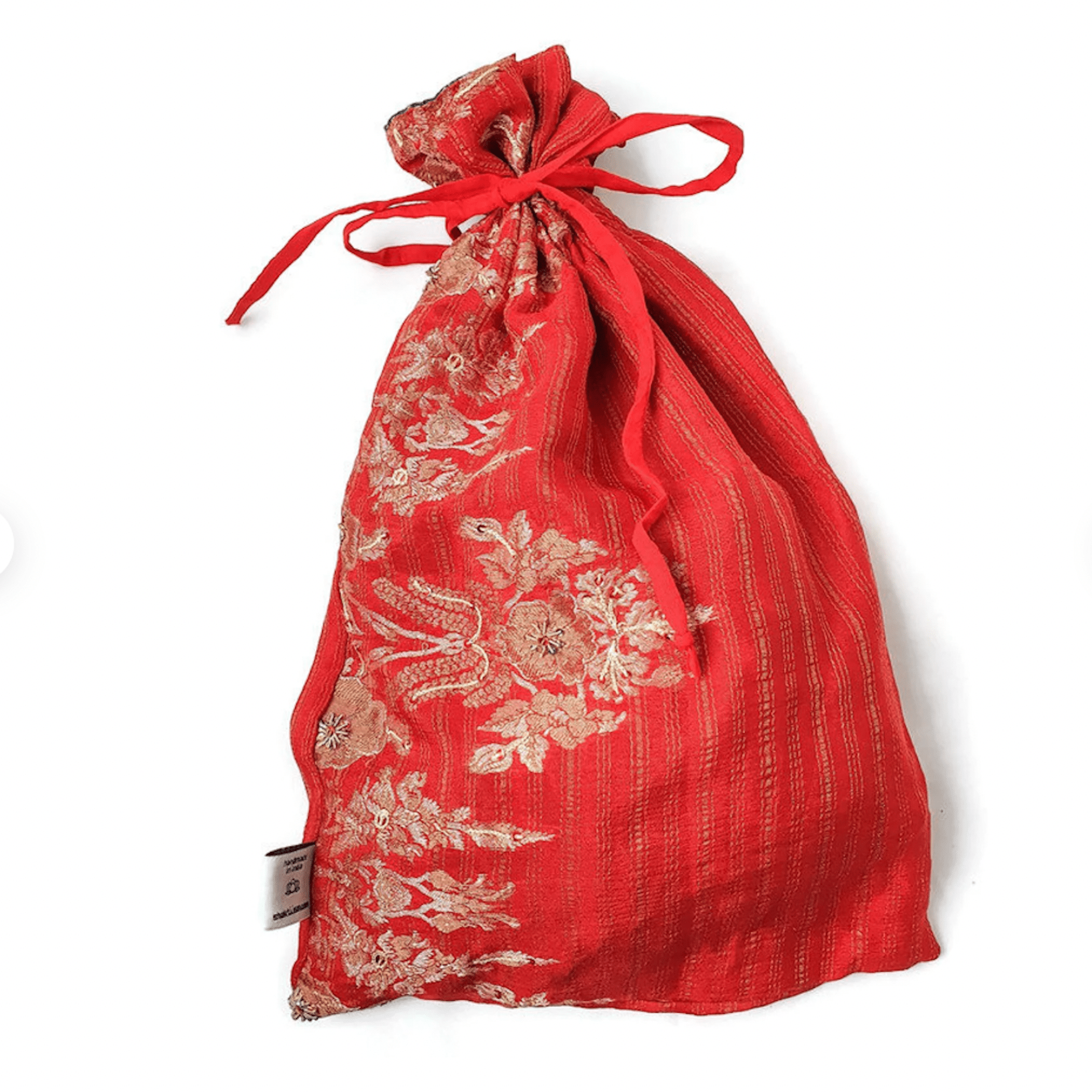 Red drawstring bag with floral patterns on a white background
