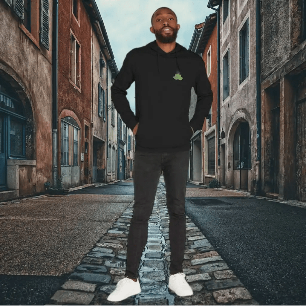 Man standing in a narrow cobblestone street with old buildings on either side
