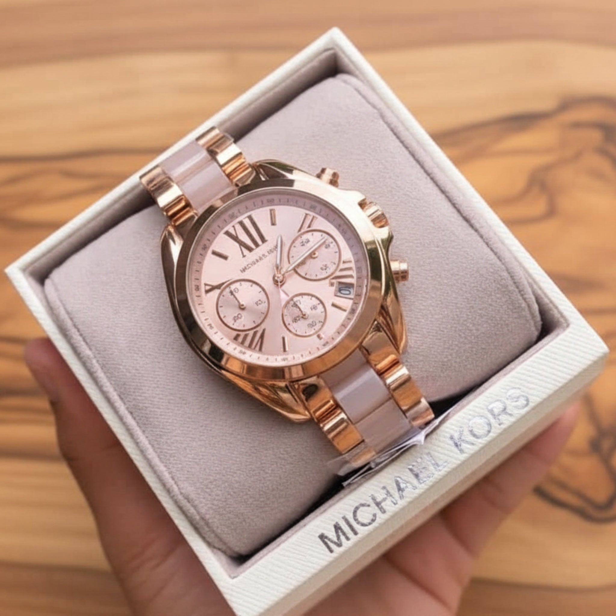Rose gold watch in a Michael Kors box with a green leafy background