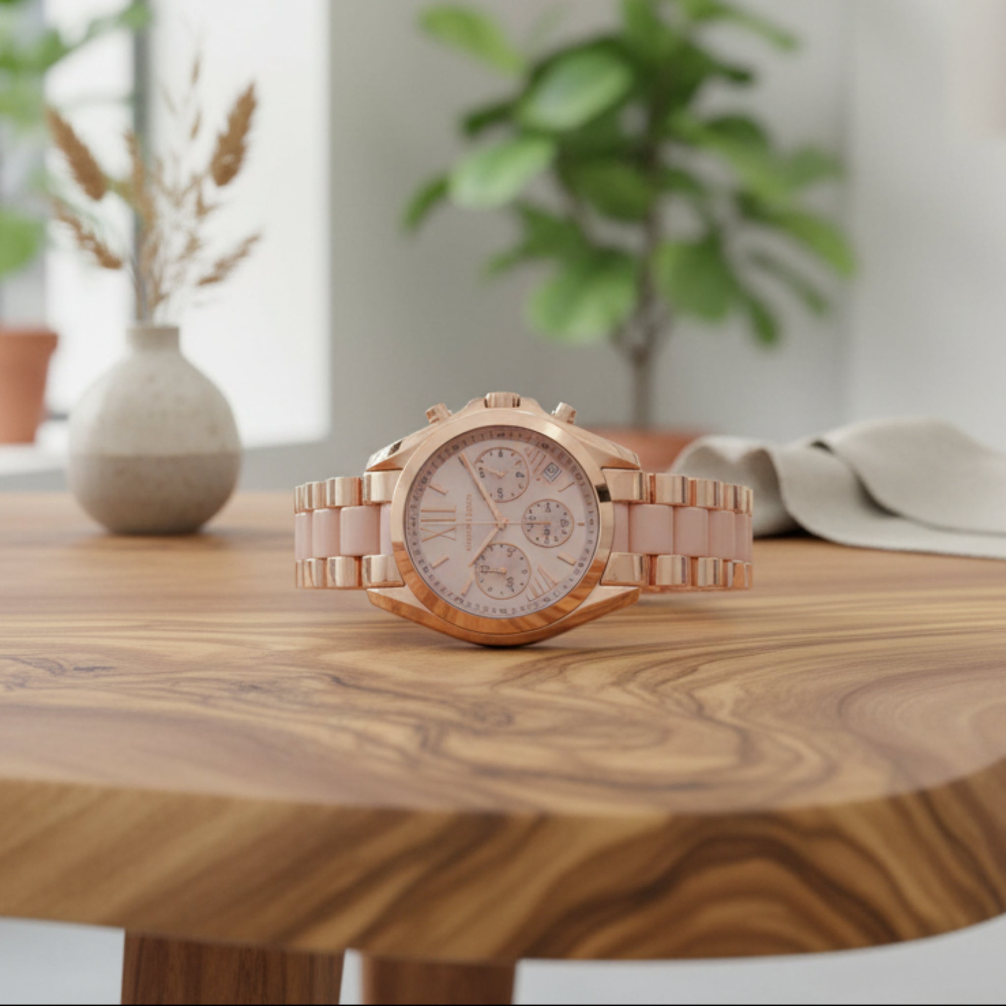 Rose gold watch with detailed face on a white background