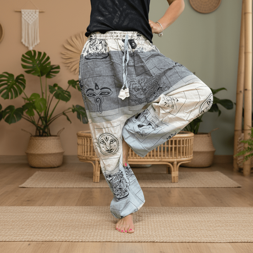 Person wearing patterned pants in a room with plants and wooden furniture