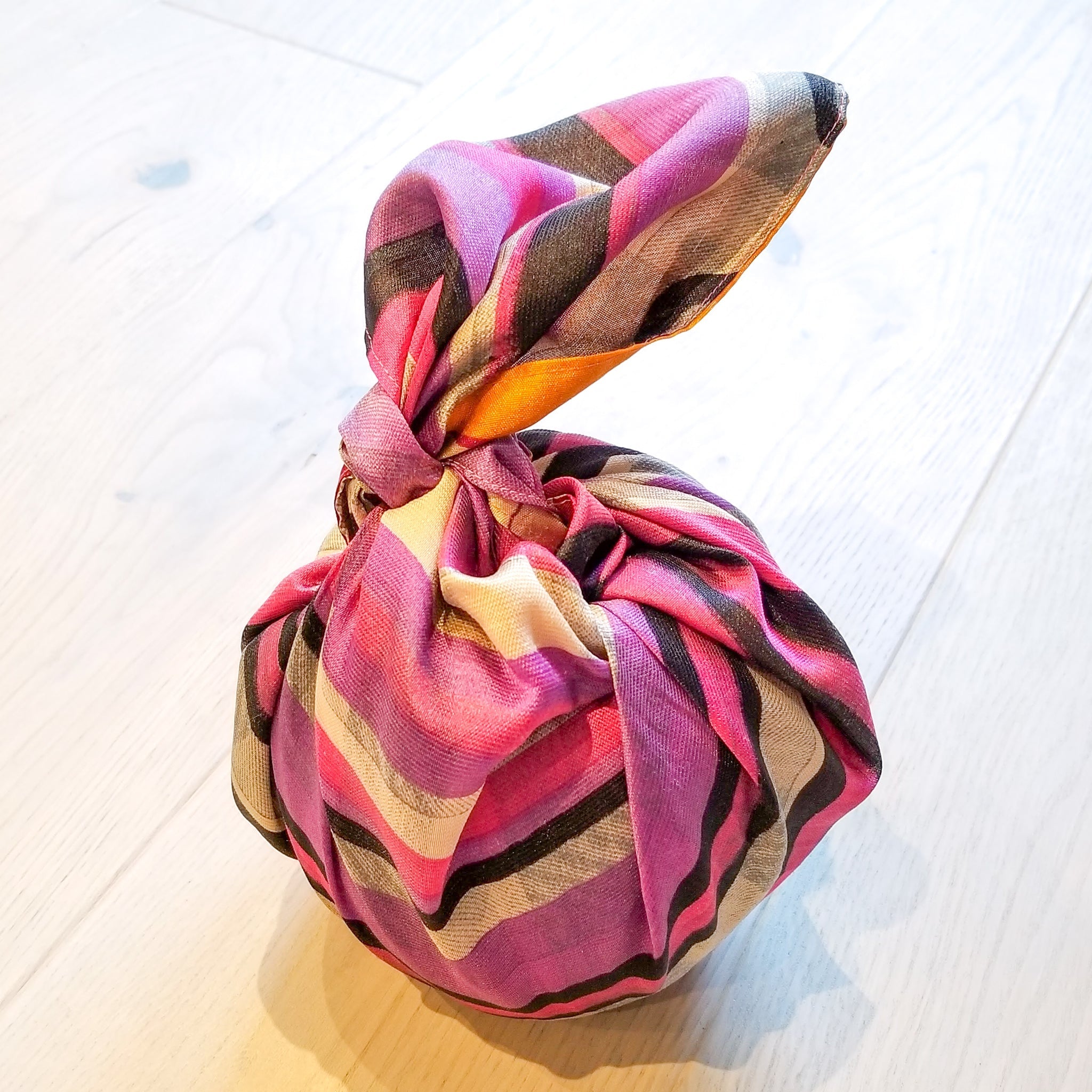 Colourful striped gif on a light wooden floor