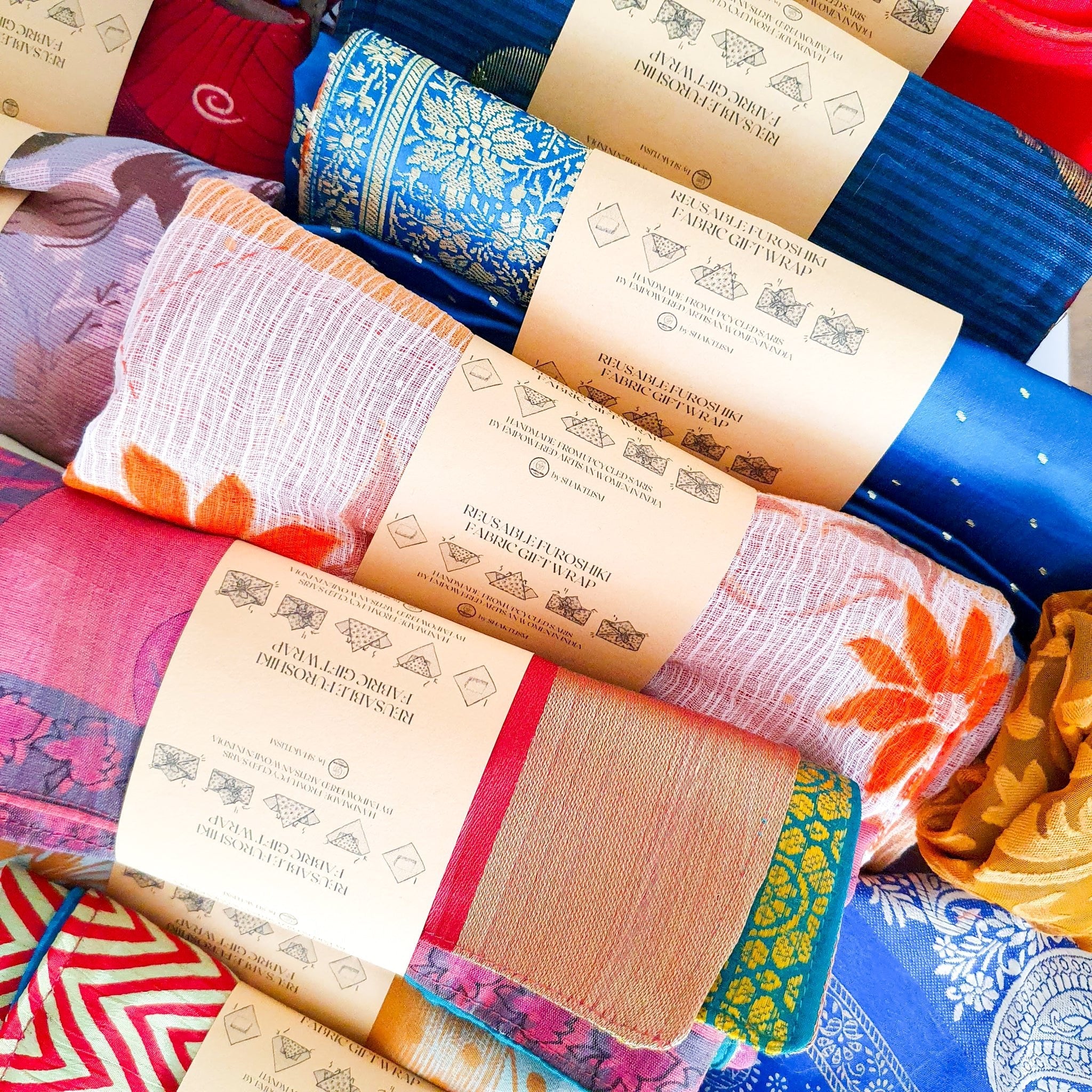 Collection of colorful fabric swatches with brand labels on a textured surface.
