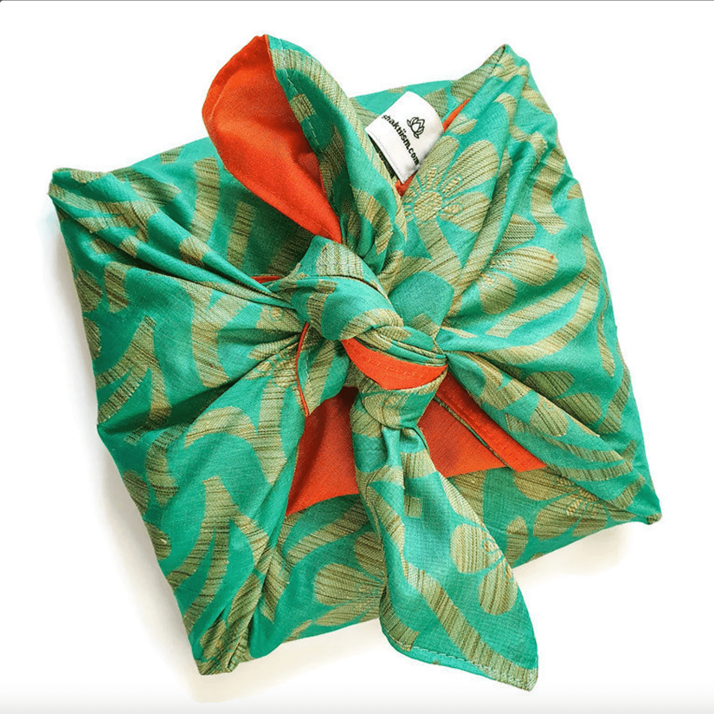 Green patterned gift wrap fabric bow with orange centre on a white background