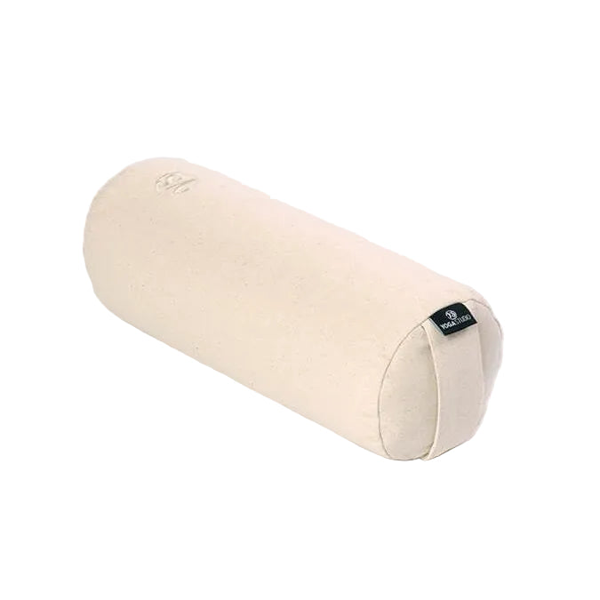 A natural beige cotton cylindrical yoga bolster pillow with a small black brand tag on the end, shown on a solid white background.