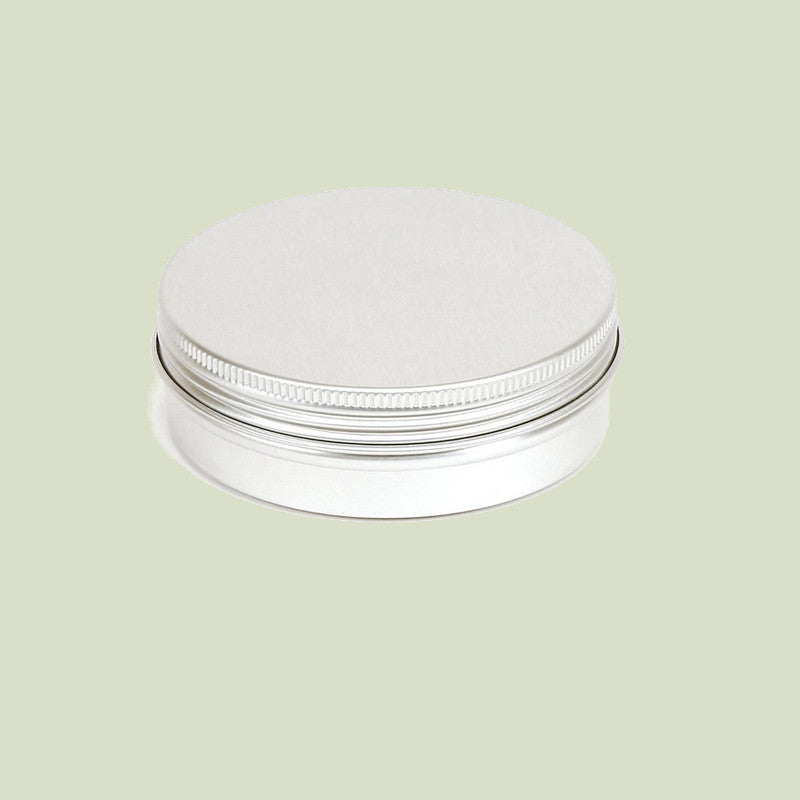 Silver metal jar with lid on a light green background