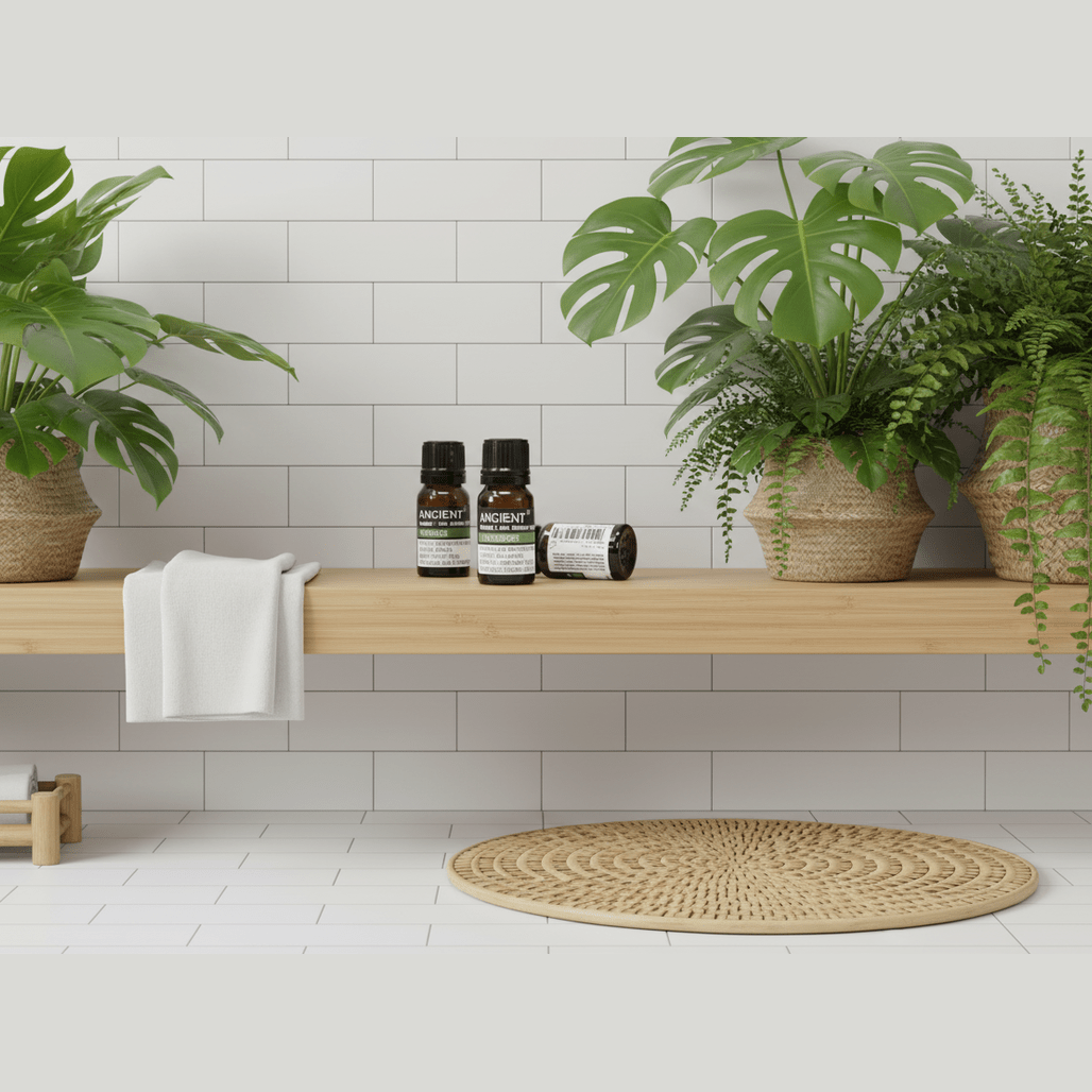 Bathroom setting with plants, essential oils, and a towel on a wooden shelf.
