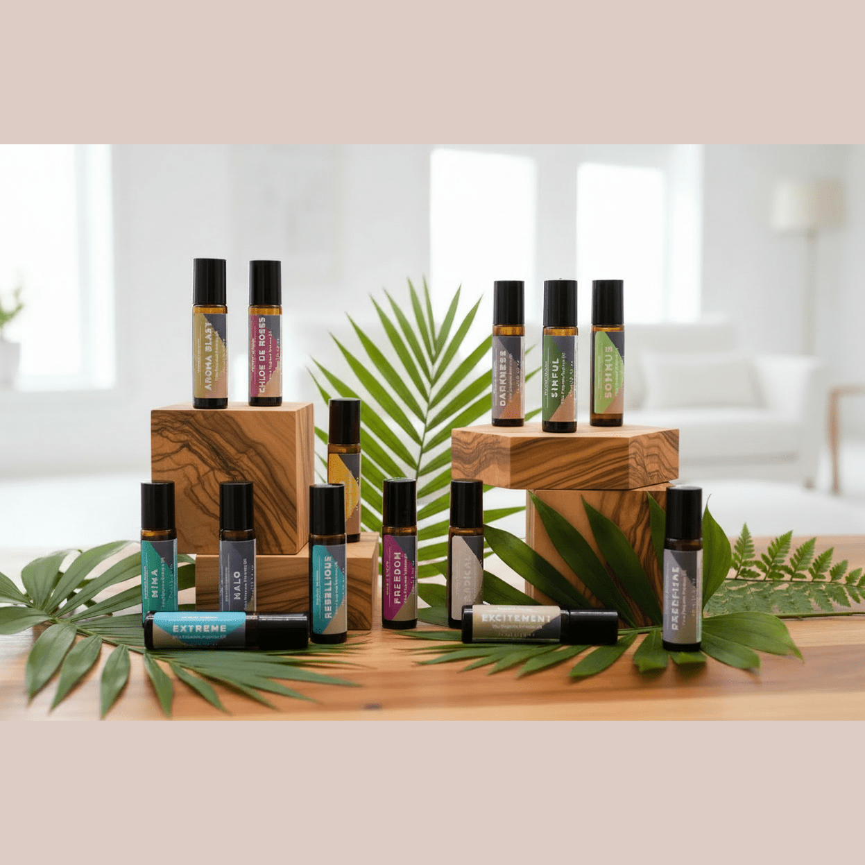 Collection of roller bottles containing perfume oil on wooden stands with green leaves in a bright room.
