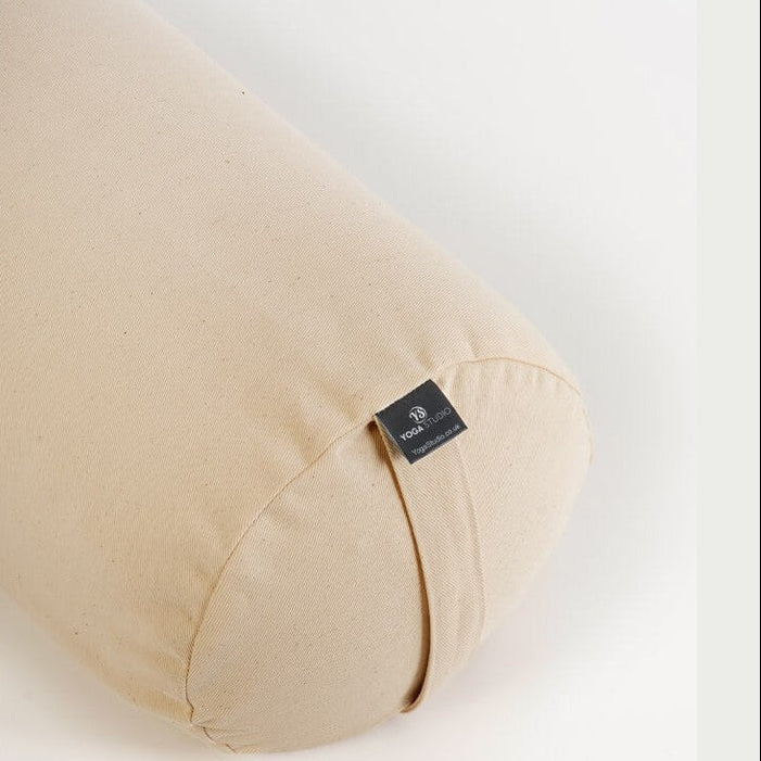 Beige yoga bolster with a brand tag on a white background