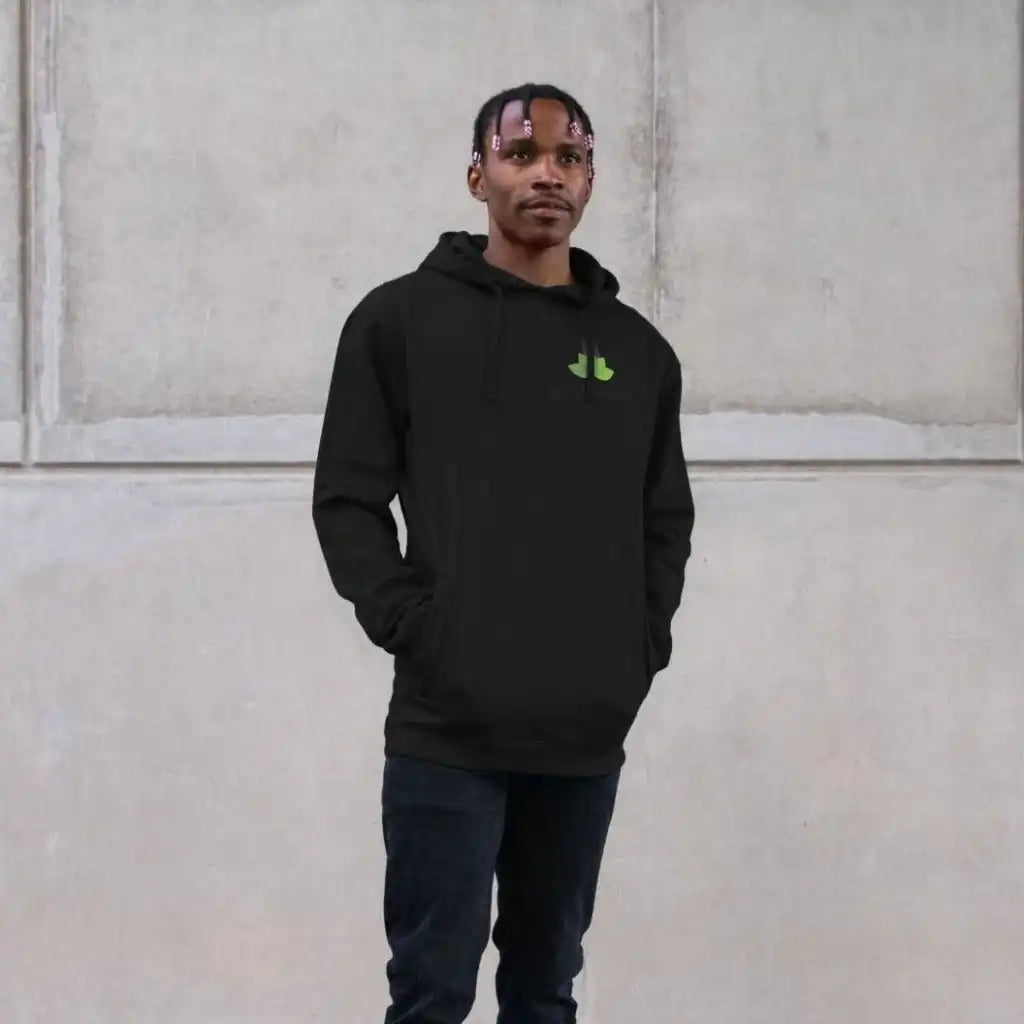 Person wearing a black hoodie with a green logo against a light-colored wall