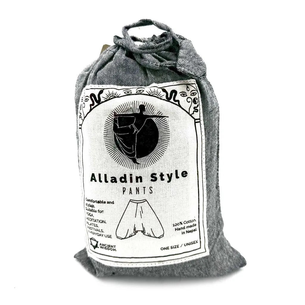Packaged yoga pants in a cotton pouch with a label on a white background
