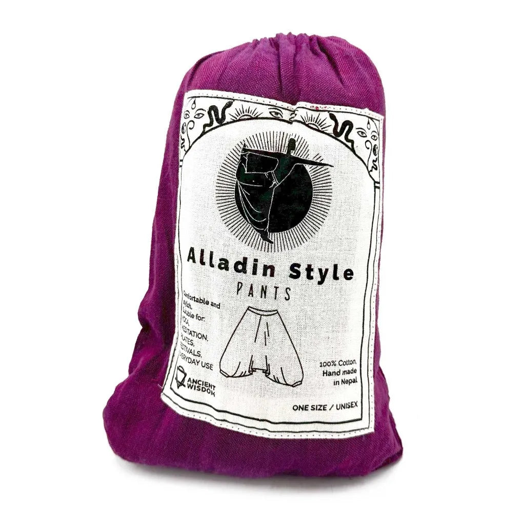 Packaged Aladdin yoga pants in a cotton pouch with a label on a white background