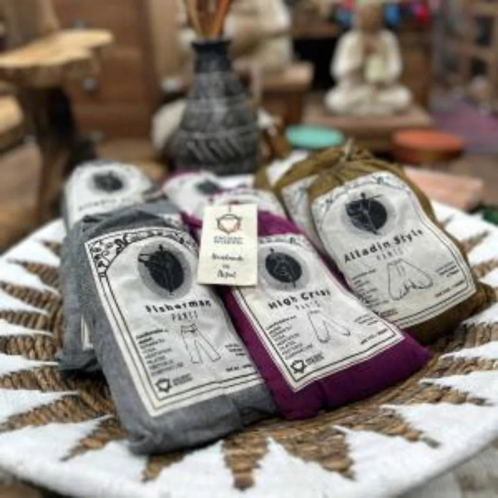 Packaged yoga pants in cotton pouches with labels