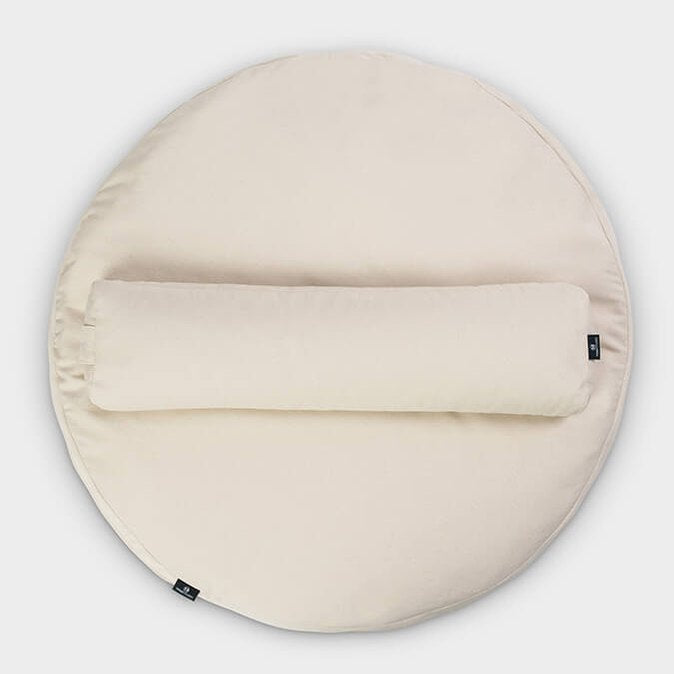 Round beige cushion with a yoga beige pillow on a white background