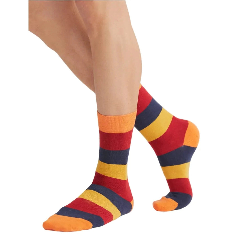 Colorful striped socks worn by a person on a white background