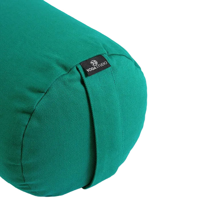 Green yoga bolster with a brand label on a light gray background