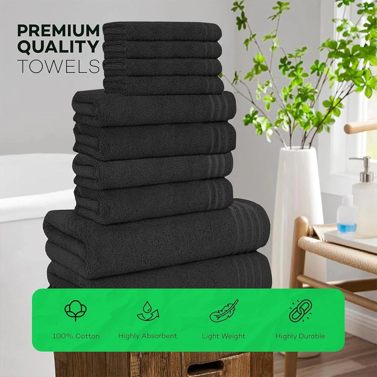 Stack of black towels with green label in a bathroom setting