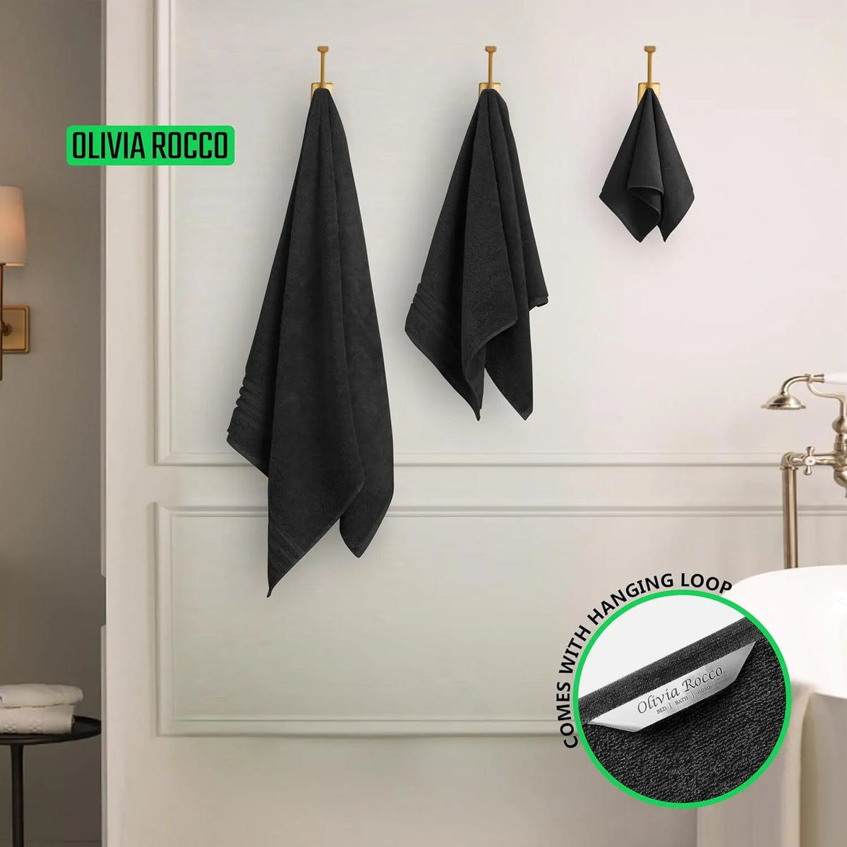 Black towels hanging on a wall with 'Olivia Rocco' branding.