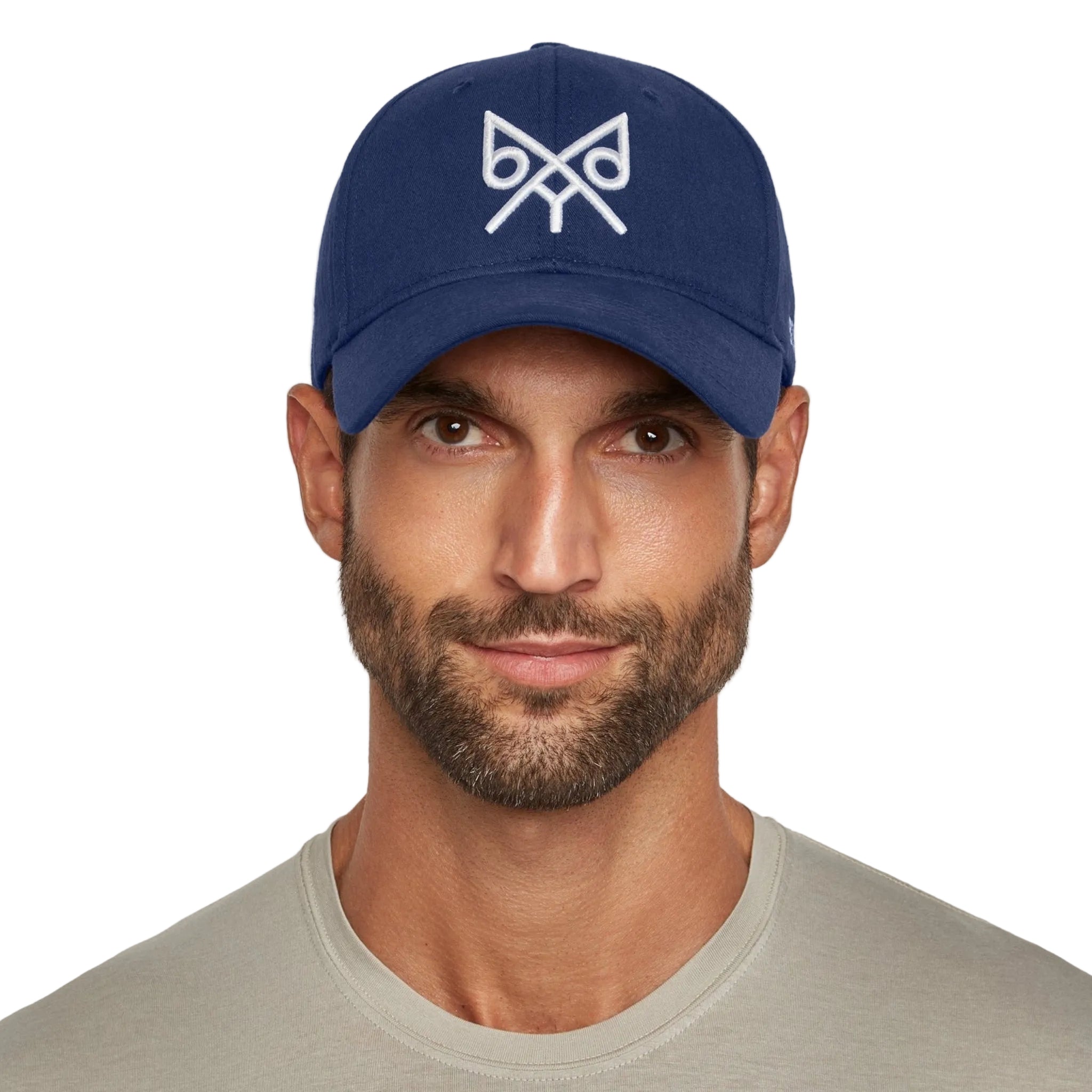Man wearing a navy blue cap with a logo on a white background