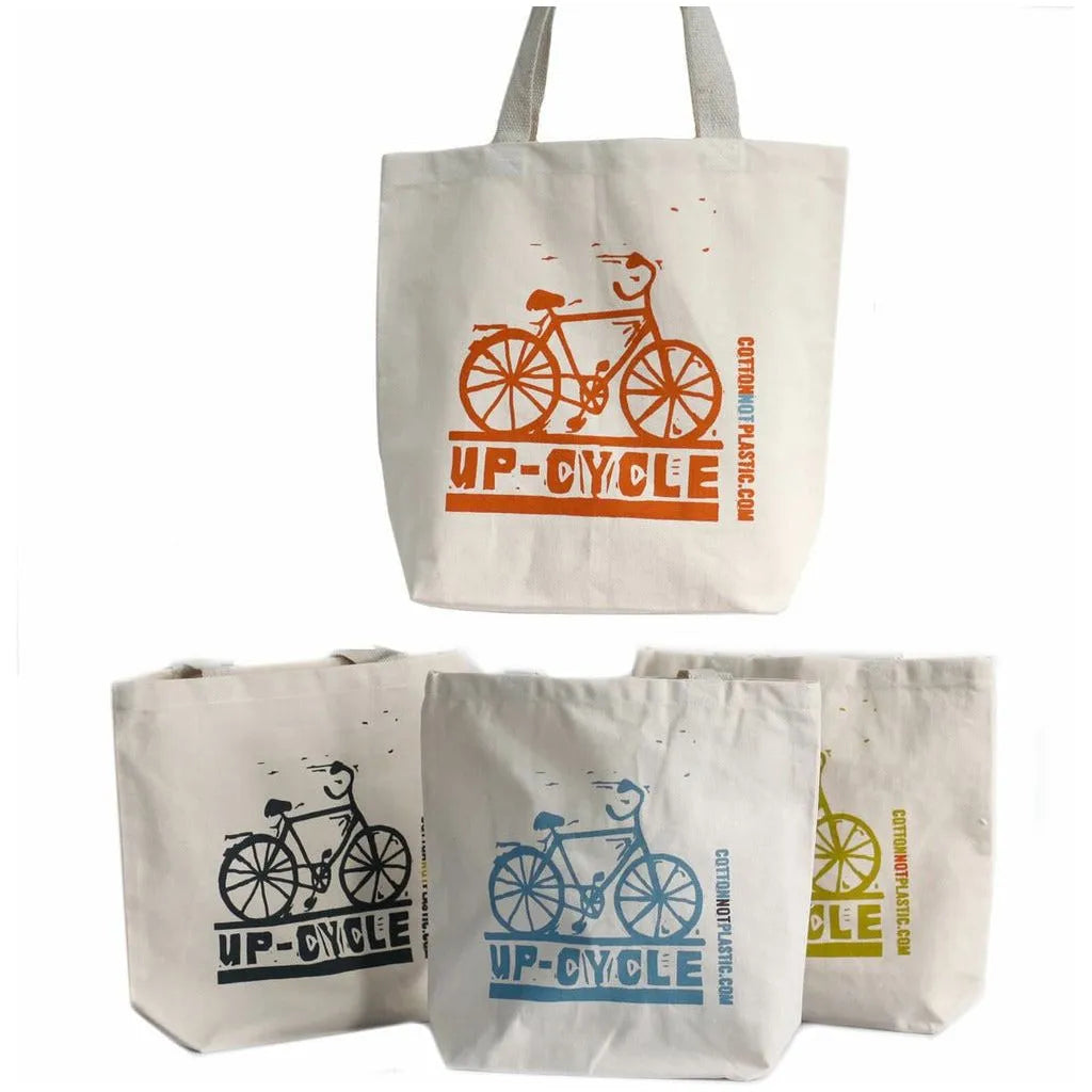 Set of four tote bags with bicycle designs and 'UP-CYCLE' text on a white background