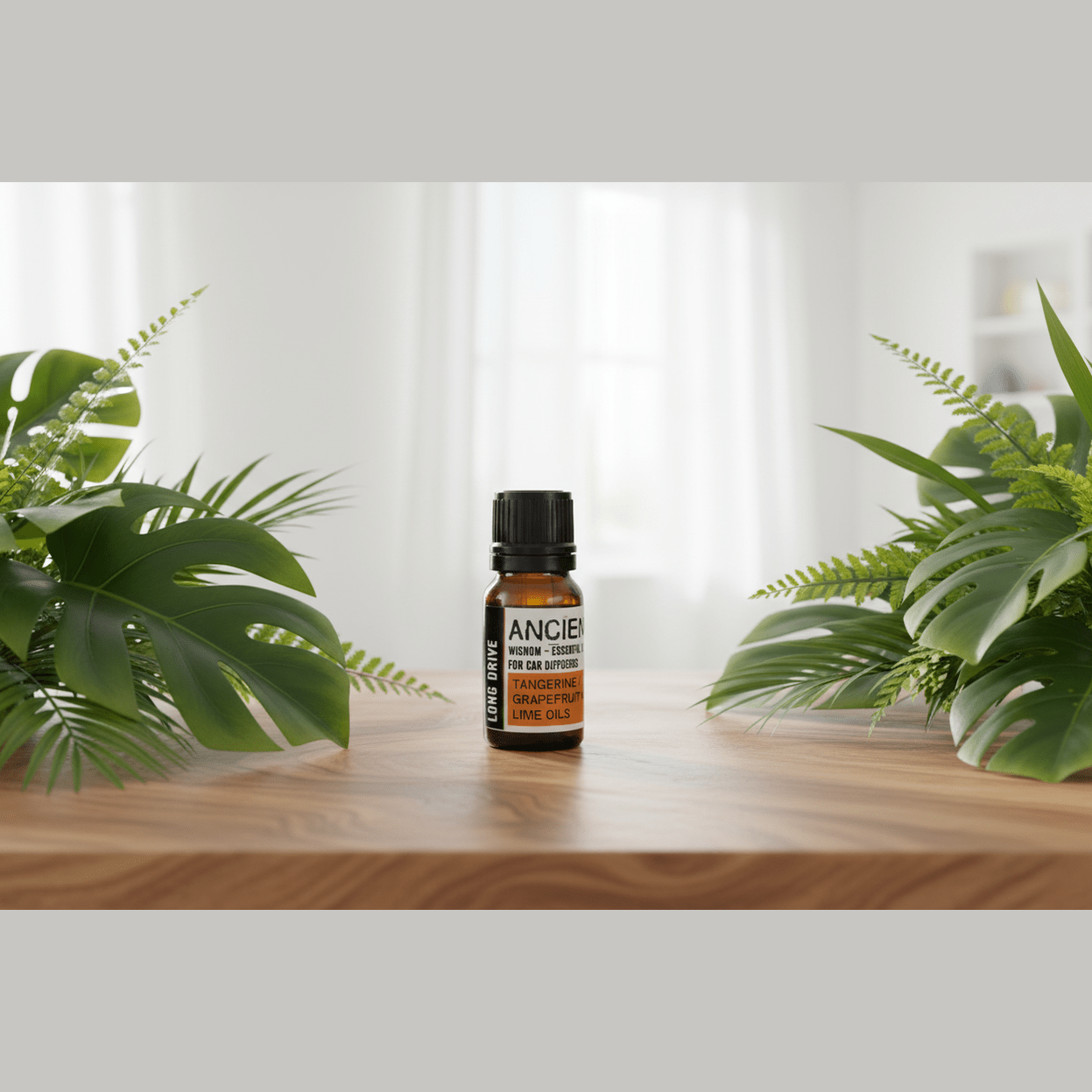 A bottle of essential oil labelled 'Long Drive' on a wooden surface with plants in the background.