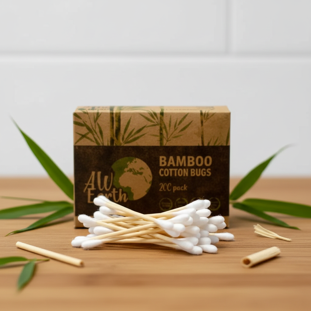 A box of All Earth Bamboo Cotton Bugs 200 pack, with several cotton swab sticks and loose pieces arranged on a wooden surface with green leaves in the background.