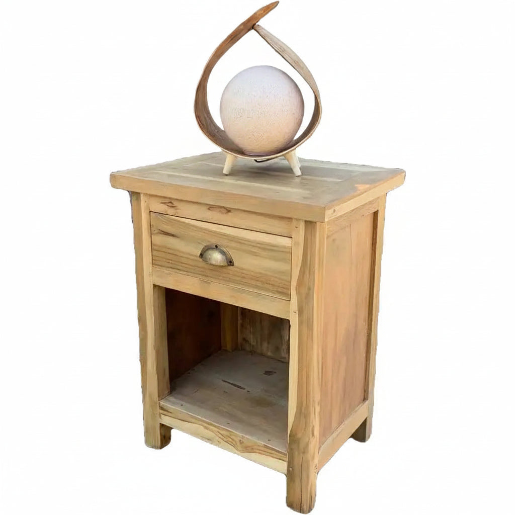A light natural wood nightstand with a single drawer and open lower shelf, shown on a plain white background. A decorative coconut lamp is placed on top of the nightstand.