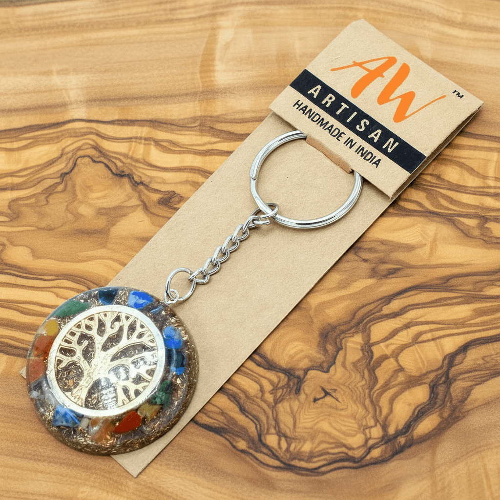 Keychain with tree design on a wooden surface, featuring 'Artisan' branding.