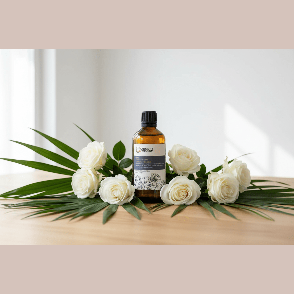 Bottle of skincare product with white roses and green leaves on a wooden surface