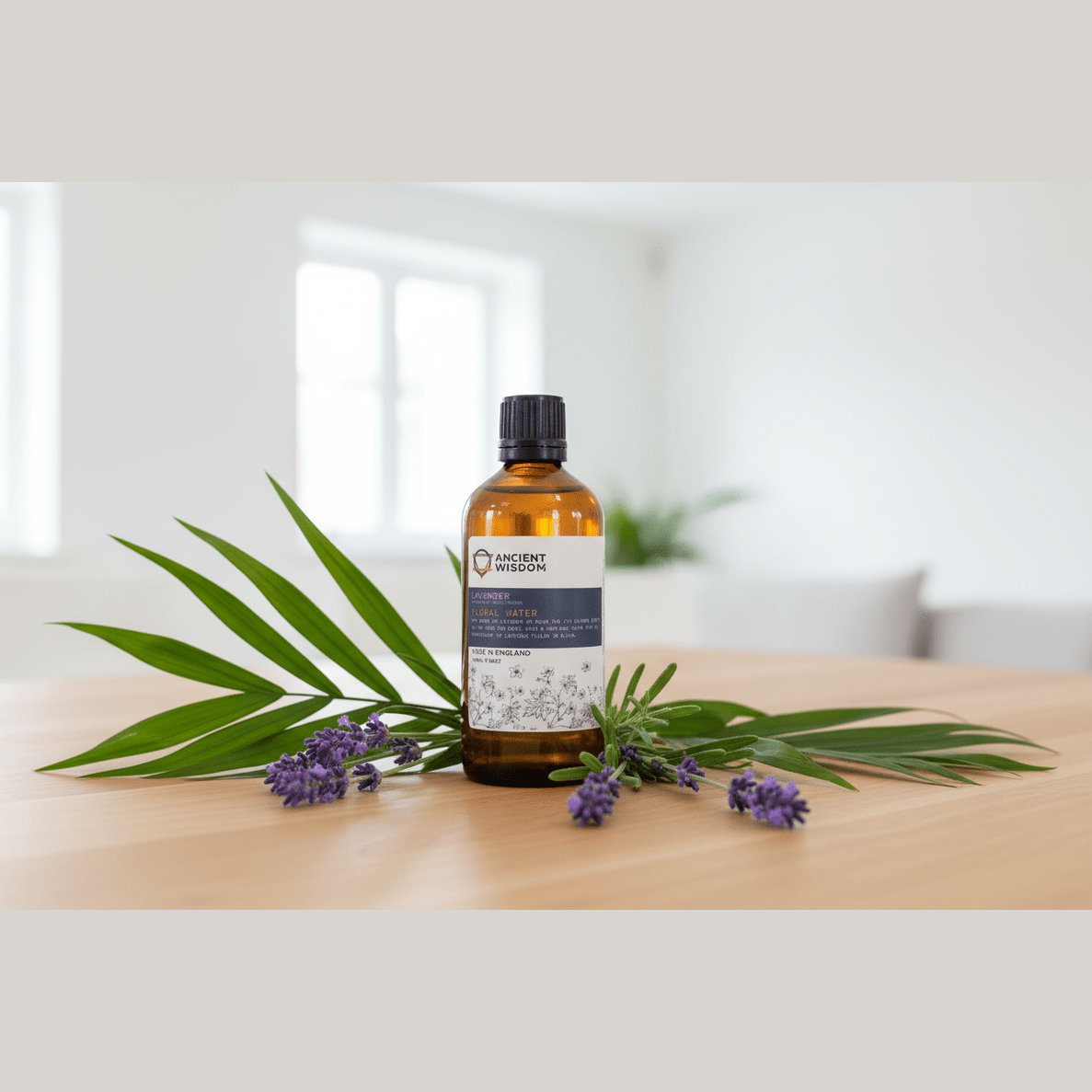 Bottle of essential oil with lavender flowers and leaves on a wooden surface