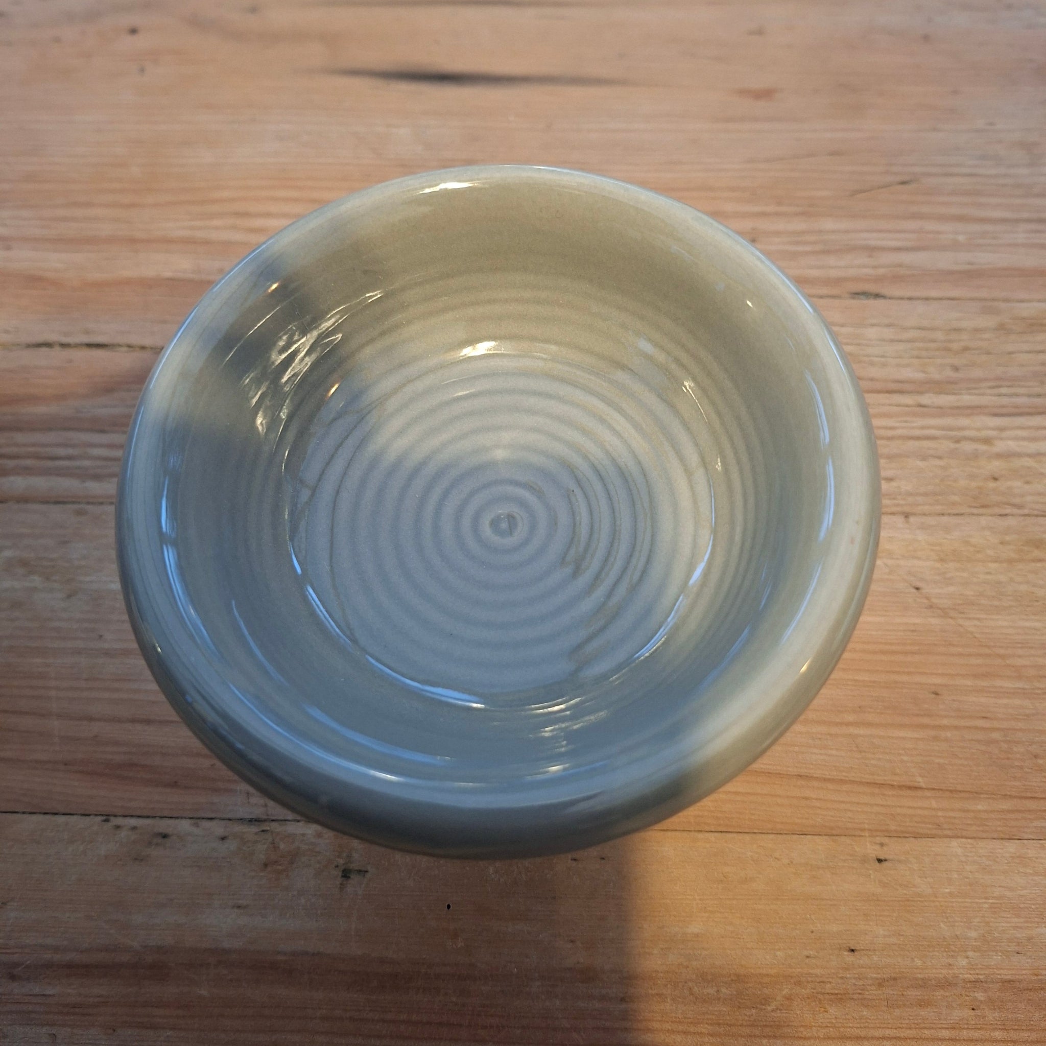 Ceramic wax melt burner bowl on a wooden surface