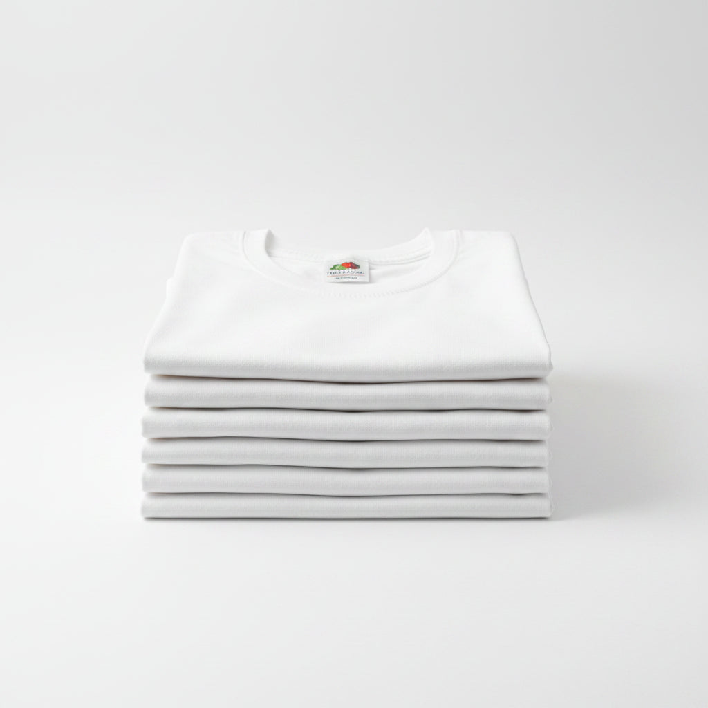 Folded white t-shirt with a brand label on a wooden surface