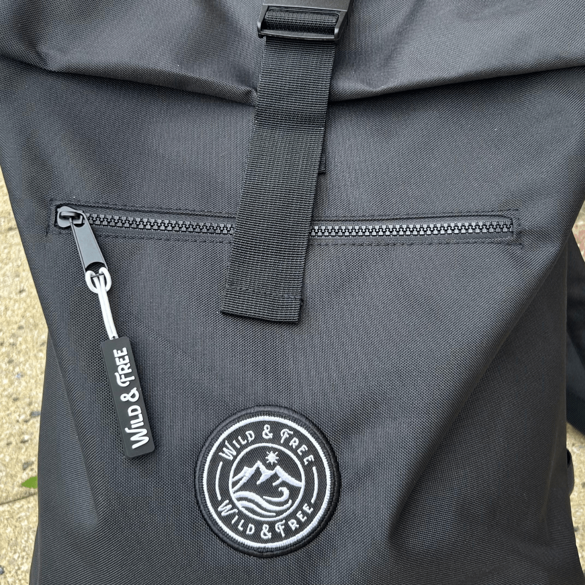 Gray backpack with a visible brand logo and text on a textured surface