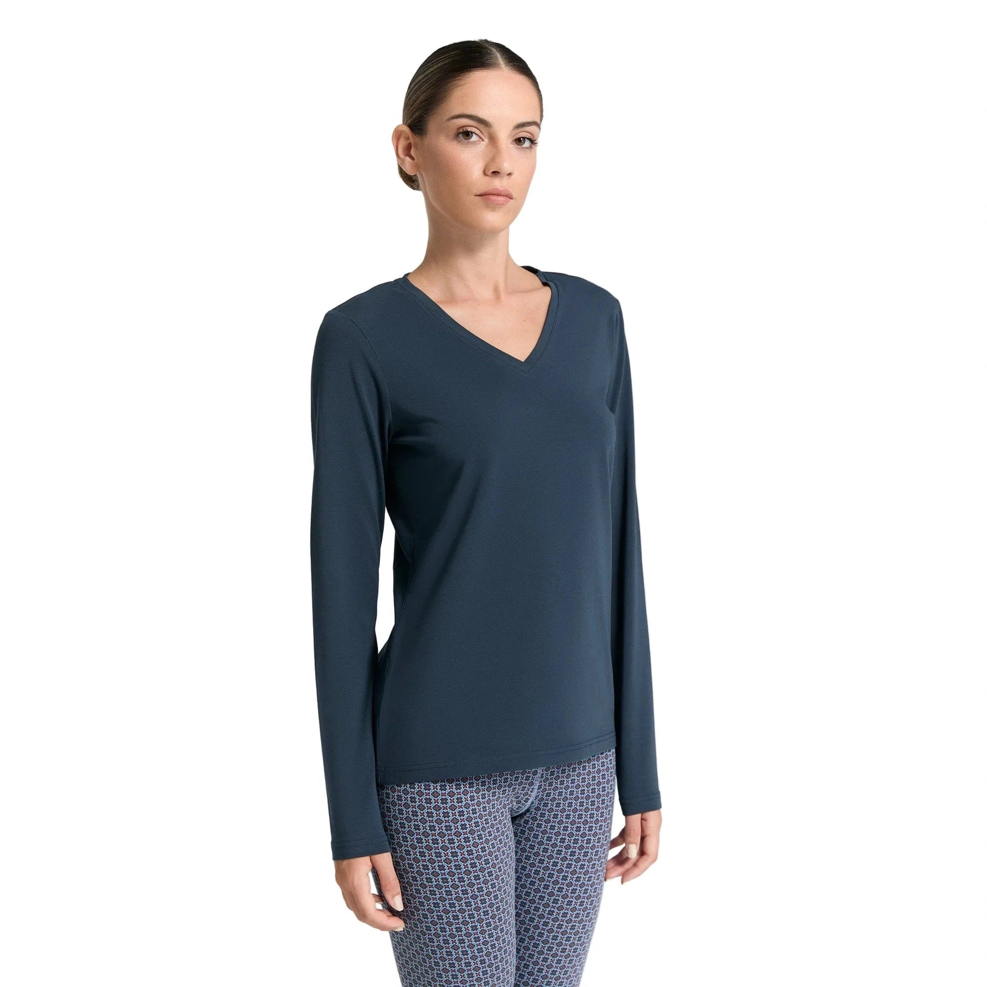 Woman wearing a dark blue long-sleeve top on a white background