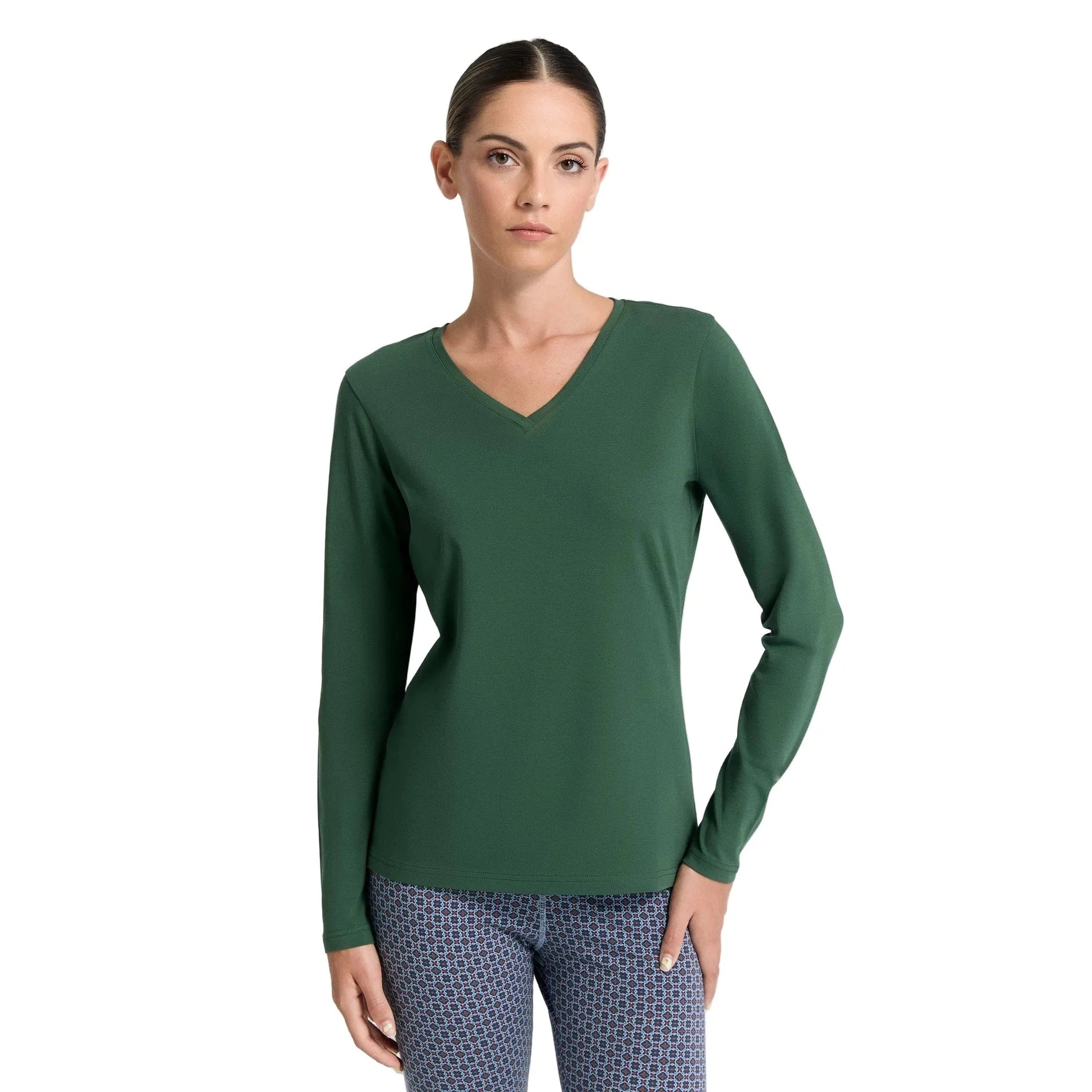 Woman wearing a green long-sleeve top on a white background
