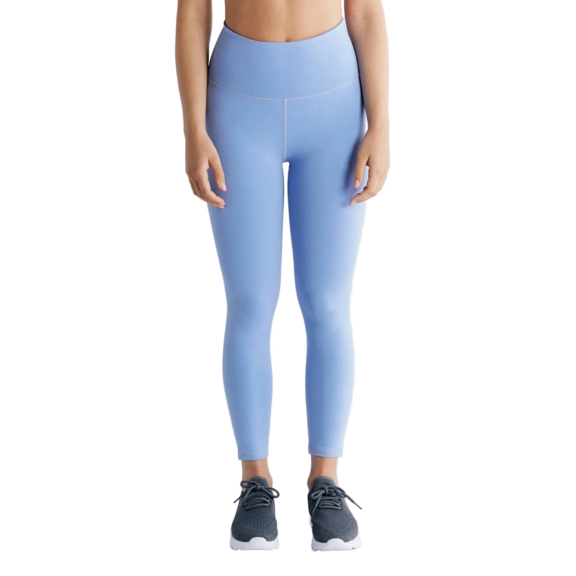 Person wearing light blue leggings on a plain background