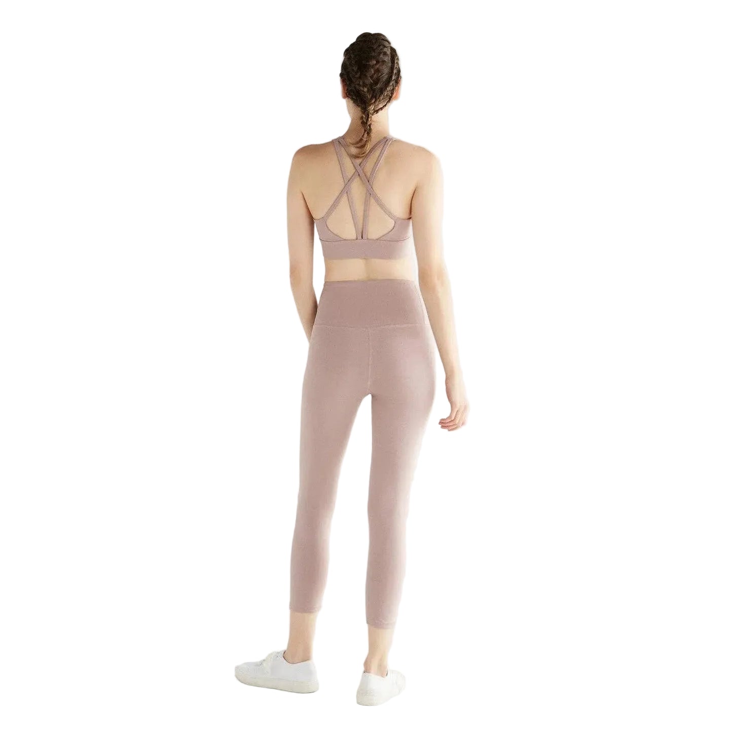 Person wearing a pink sports bra and leggings set on a white background