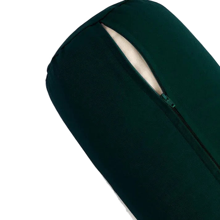Dark green yoga bolster on a light grey background