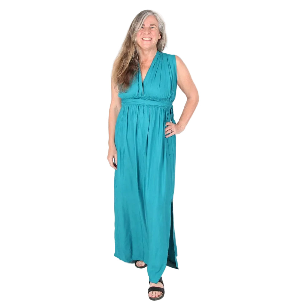 Woman wearing a teal sleeveless dress on a white background