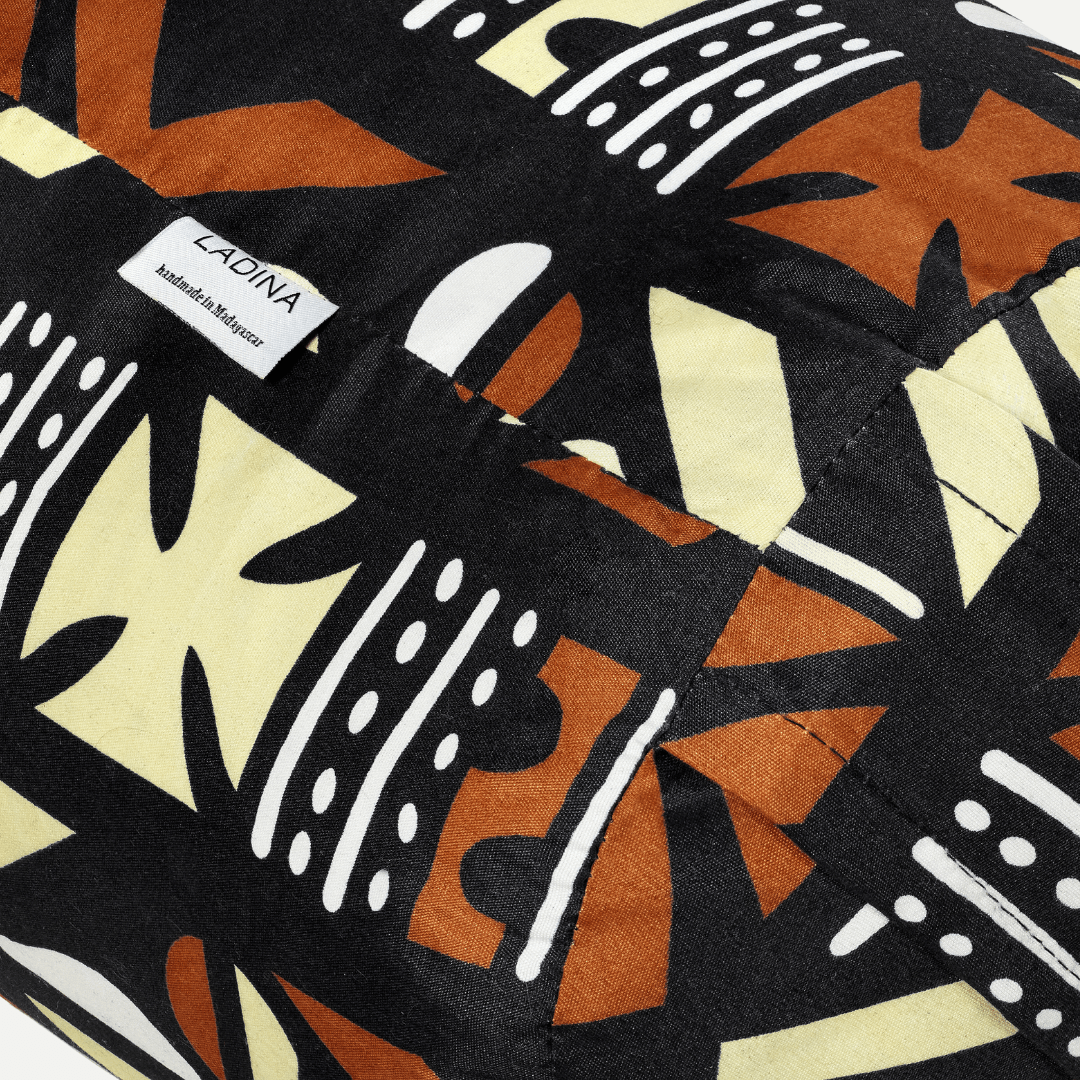 Close-up of a fabric with abstract patterns and a visible brand label.
