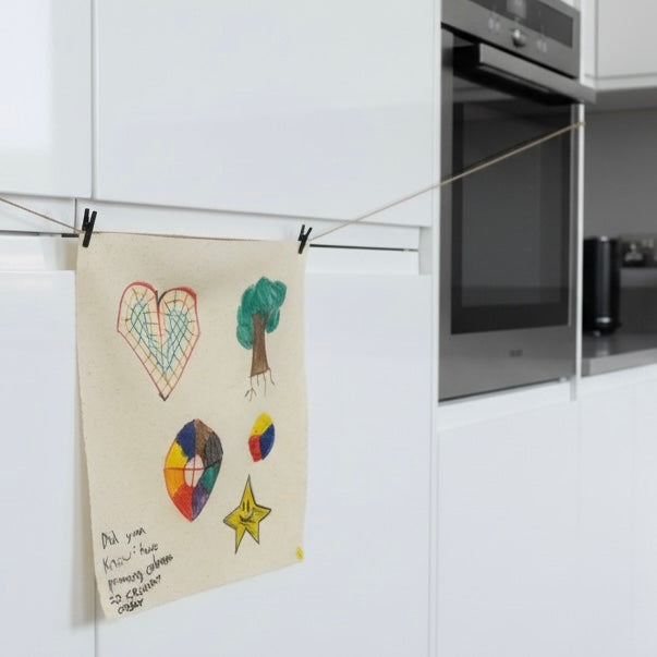 Children's drawing on a towel hanging on a kitchen rack