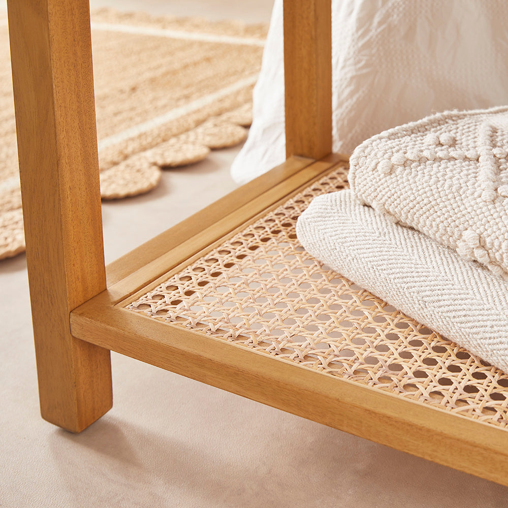Wooden bench with woven design and white bedding