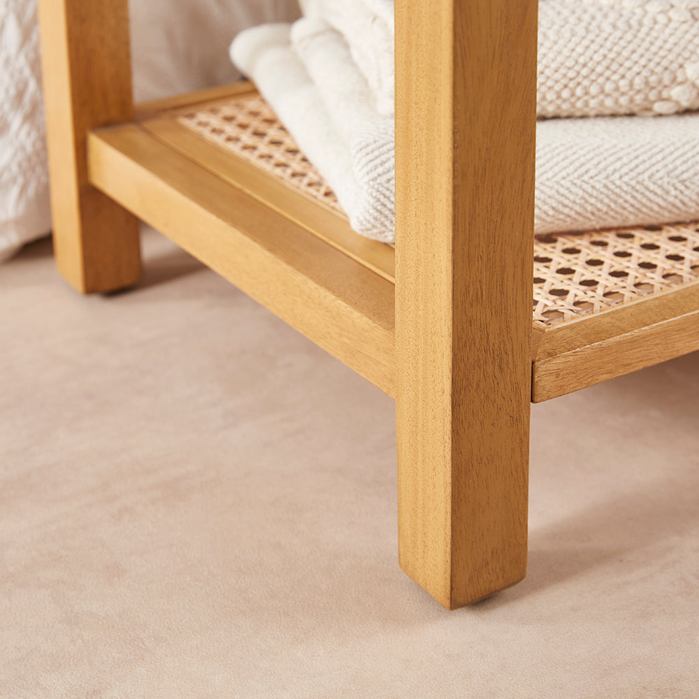 Wooden shelf with woven base on a beige carpet