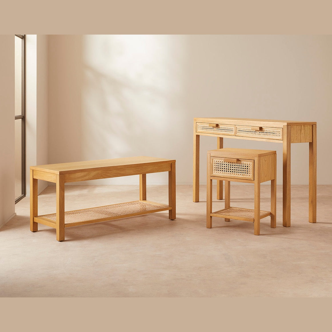 Set of wooden bedroom furniture including a bench, table, and side table in a neutral setting.