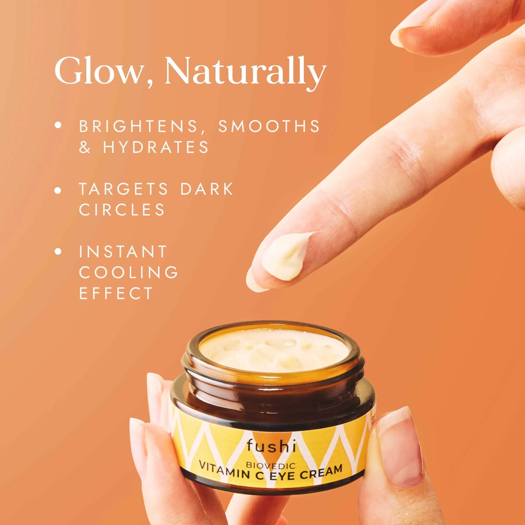 Fushi Vitamin C Eye Cream jar with a hand applying cream and text on an orange background