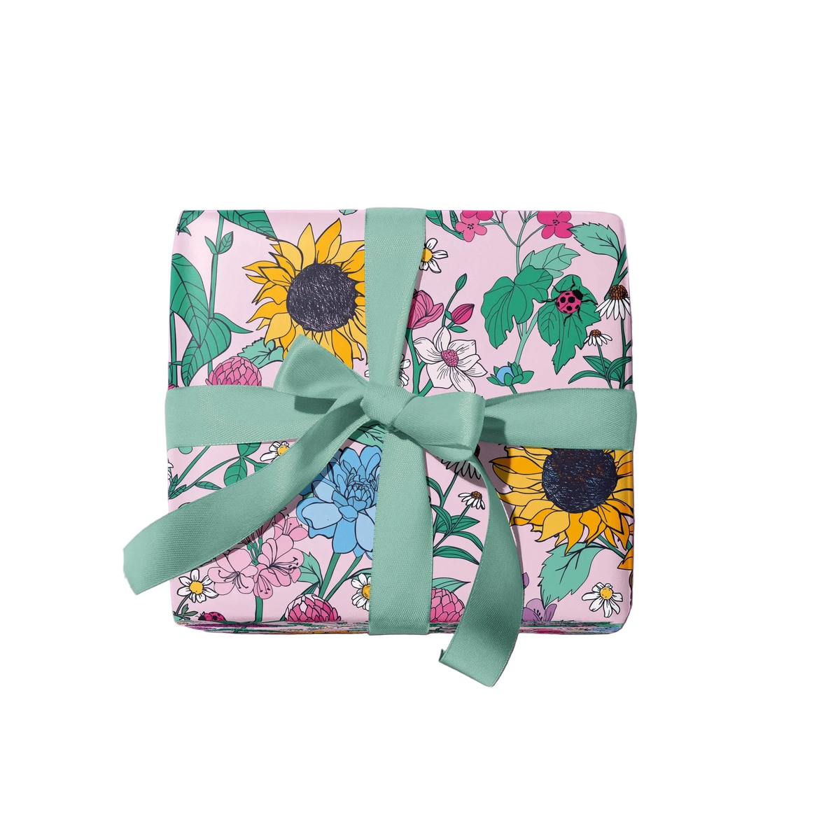 A square gift box wrapped in pink floral paper with sunflowers, green leaves, and small flowers, tied with a mint green ribbon and bow, on a plain white background.