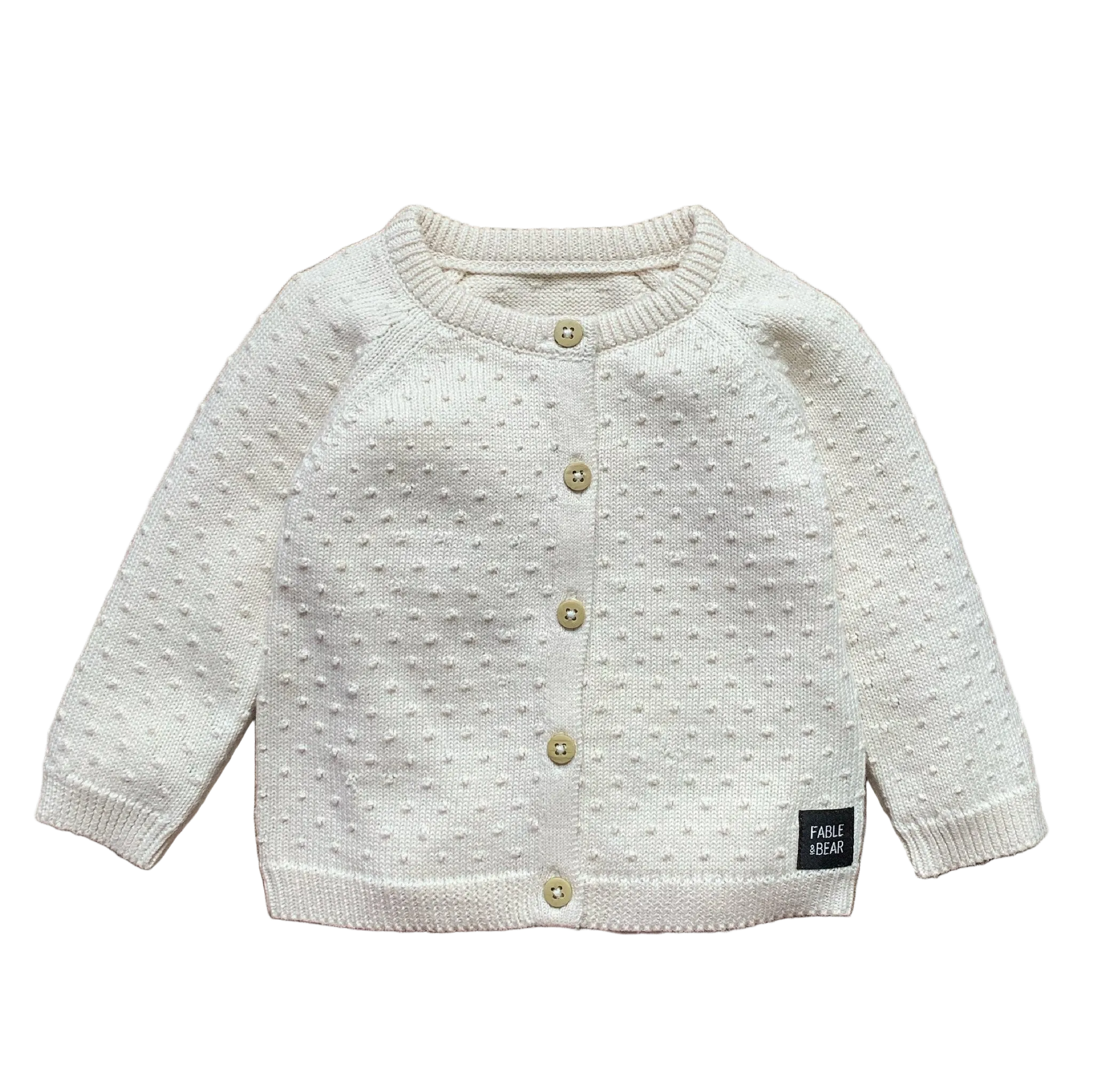 White baby cardigan with button details on a white background