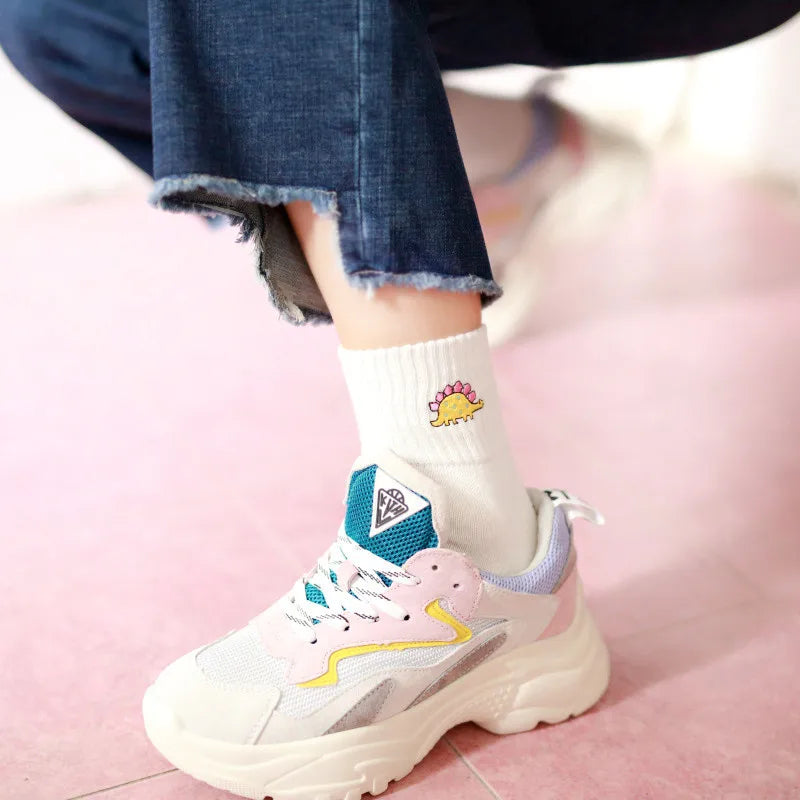 Colorful sneakers with a unique design on a pink surface
